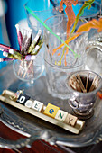 Cocktail umbrellas and toothpicks with scrabble pieces on silver tray in Auckland home North Island New Zealand