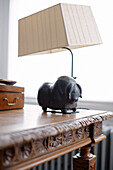 Sheep lamp on carved wooden table in Notting Hill home West London UK