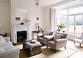 Pair of armchairs at fireside in Bicester living room Oxfordshire England