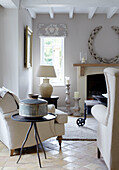Cream lamp at window in Buckinghamshire living room with cream armchair and sofa UK