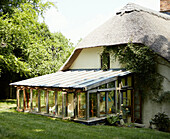 Conservatory extension on thatched Devonshire cottage UK