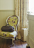 Yellow upholstered chair with doctor's bag in Whitley Bay home Tyne and Wear England UK