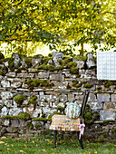 Up-cycled chair and drystone wall in Northumberland England UK