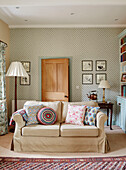 Assorted cushions on cream sofa in Hexham farmhouse Northumberland UK