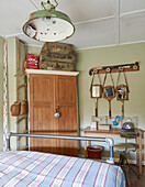 Vintage suitcases on wooden wardrobe with sports equipment in Sunderland bedroom Tyne and Wear England UK