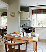 Wooden chair at table in open plan kitchen of County Durham home England UK
