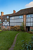Garden path and timber framed and brick exterior of Speldhurst home Kent England UK