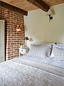 Fox head on exposed brick wall above double bed in Grade II listed Tudor bastle Northumberland UK