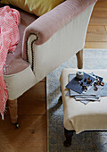 Fabric samples and rivet pins on footstool in Kent home, England, UK