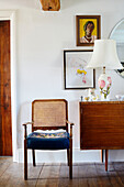 Wicker chair with wooden leaf table and lamp with magnolia base in Yorkshire home, England, UK