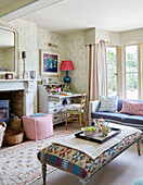 Writing desk with cushions and tapestry ottoman in Warwickshire farmhouse, UK