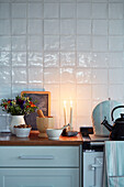 Kitchenware with lit candles on worktop in Worcestershire home, England, UK