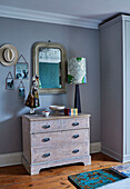 Lamp and mirror on chest of drawers in modernised Regency home, Cotswolds, England, UK