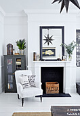 White armchair with grey cabinet and crate in Edwardian London flat, UK