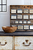 Swedish bowl on French 19th century haberdashery counter in renovated Cotswolds cottage, UK