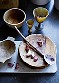 Swedish wooden bowls and ceramic twig sppon with garlic in renovated Cotswolds cottage, UK