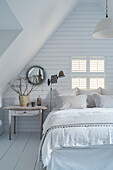 New England style attic bedroom in renovated Cotswolds cottage, UK