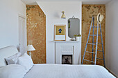 Step ladder in bedroom with stripped walls in Camber coastguards cottage East Sussex, UK