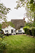 Garden exterior of thatched Berkshire cottage, England, UK
