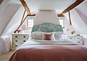 Pink blanket on double bed in attic of Berkshire cottage, England, UK
