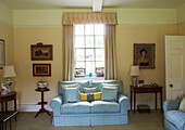 Light blue checked sofa at window in Syresham home, Northamptonshire, UK
