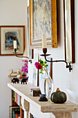 Wall mounted candle holders with ornaments on mantlepiece in Oxfordshire farmhouse, UK