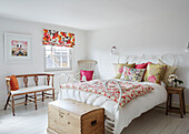 Floral cushions quilt and blinds in bedroom of Deddington home, Oxfordshire, UK