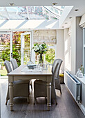 Wicker chairs at table in North Yorkshire conservatory, UK