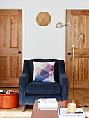 Blue armchair and desk lamp in Durham home, England, UK