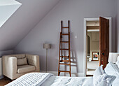 Wooden ladder and armchair in bedroom of Durham home, England, UK