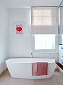 Freestanding bath at window in South East London home, UK