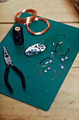 Pliers, wire and thread to make a beetle in Gladestry studio on South Wales borders