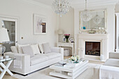 White sofa with chandelier and low coffee table in York home, UK