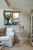 Equestrian statue on side table at window with cut leaves in West Sussex home, UK