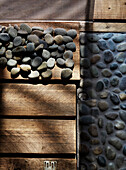 Pebbles and wooden boards in converted shipping container Bedford, UK