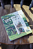 Upcycling book on wooden chair in converted shipping container in Bedford, UK