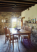 Dining table with exposed stone and beamed ceiling in renovated Yorkshire farmhouse, UK