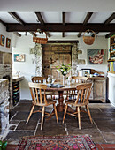 Wooden table and chairs in renovated Yorkshire farmhouse kitchen, UK