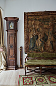 Grandfather clock and tapestry wall hanging with settee in Foix townhouse Ariege, France