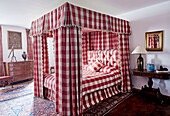 Gingham four poster bed in Foix townhouse Ariege, France