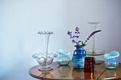 Vintage glass vases on polished wooden table in Northern home, UK