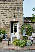 Patio table and chairs outside North Yorkshire farmhouse, UK