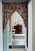 Indian fabric with view across hallway to bedroom in Oxfordshire farmhouse, UK