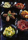 Selection of Moroccan vegetable side dishes including tomato jam chermoula zaalouk