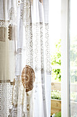 White lace curtains hang in sliding doorway of Brighton home East Sussex, England, UK