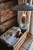 Bathroom Detail with oil lantern and box of towels and flannels inside Wooden cabin situated in the mountains of Sirdal, Norway