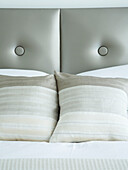 Detail of cushions and button back headboard
