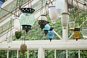 Glass lanterns hanging in conservatory