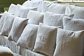 White pillows with embroidery in row