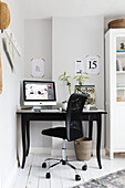 Black chair at desk with computer in Reigate home, Surrey, UK